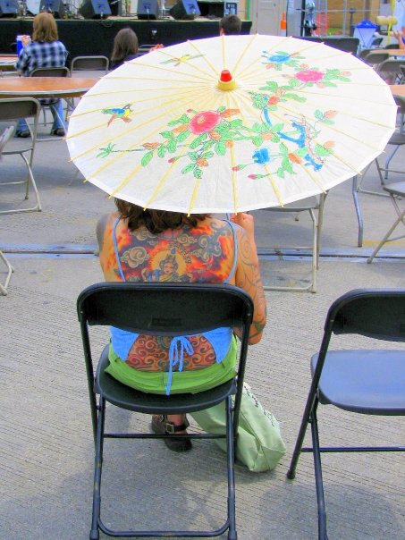 tattooed woman with parasol
