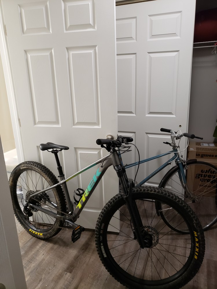 Two bikes leaning against interior doors