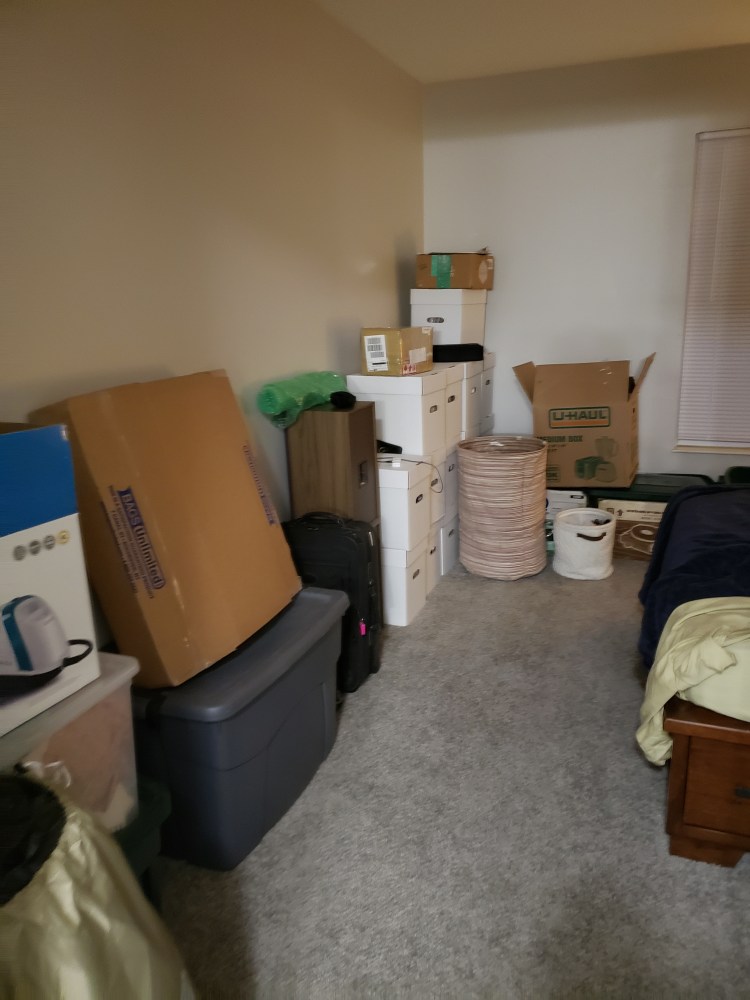 Bedroom with boxes and bins.