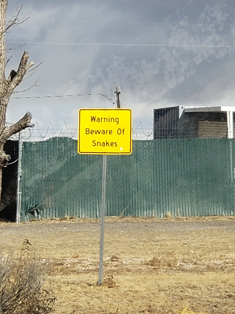 sign with warning to beware of snakes