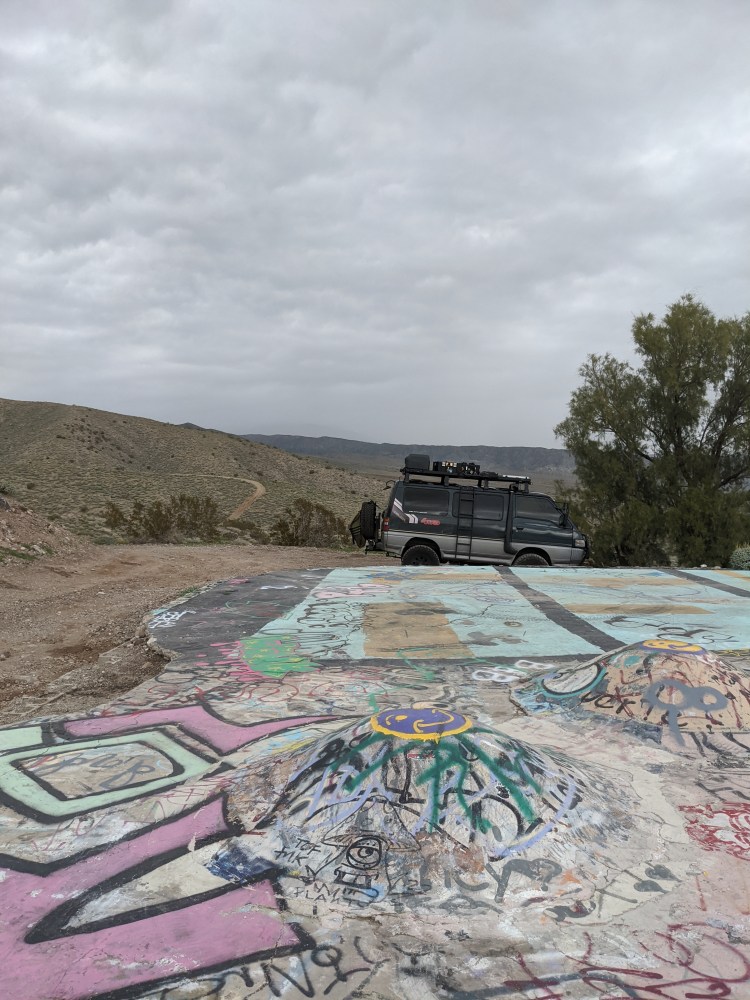 Concrete deck above Nude Bowl covered in graffiti with the van in background