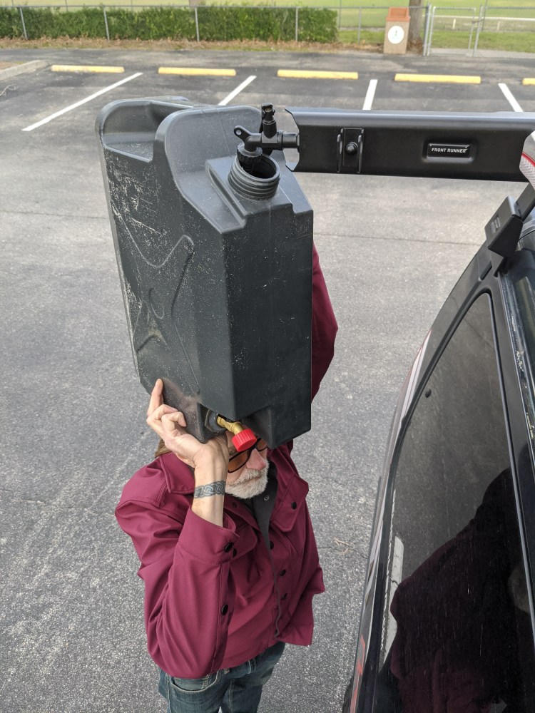 Mark with water jerry can on his head