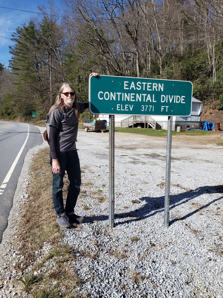 Mark at an Eastern Continental Divide sign
