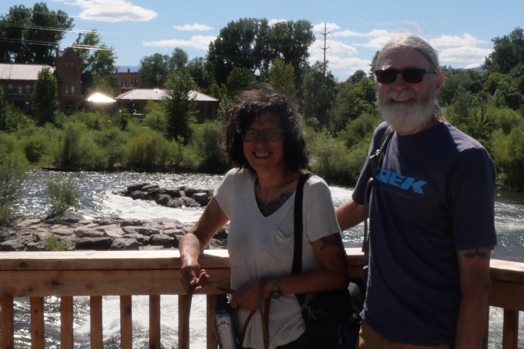 Lydia and Mark standing at a railing in from the Clark Fork River