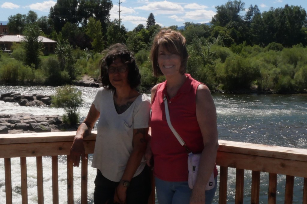 Lydia and friend standing at railing in front of Clark Fork River