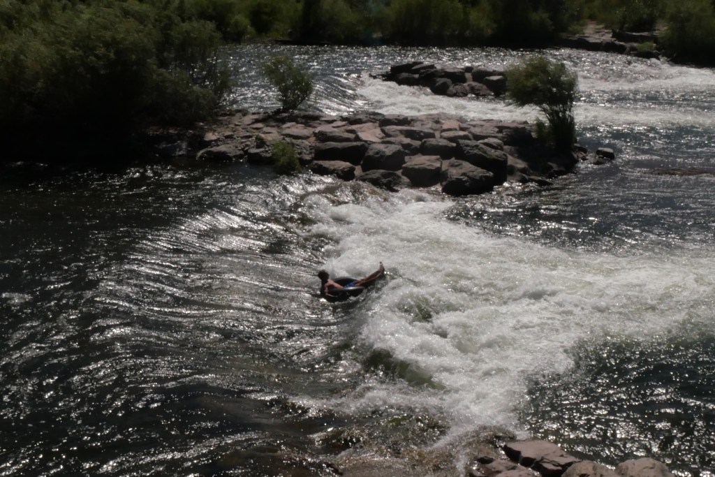 Individual going over rapids in an inner tube